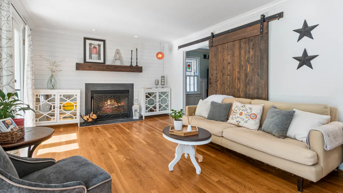 Bright farmhouse living room with barn door and fireplace