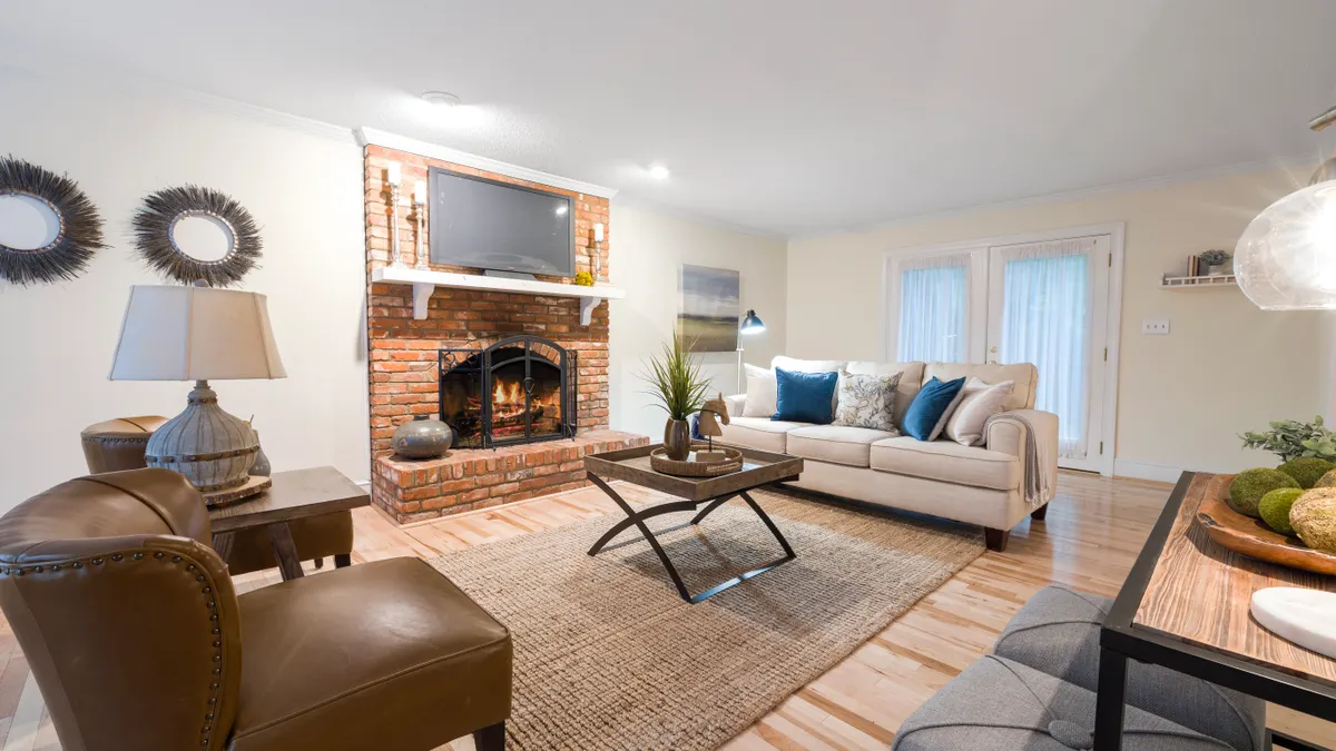 Neutral farmhouse living room with fireplace and natural textures