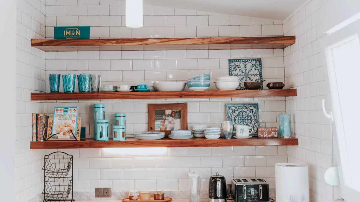 Open kitchen shelves styled with dishes, jars, and decor